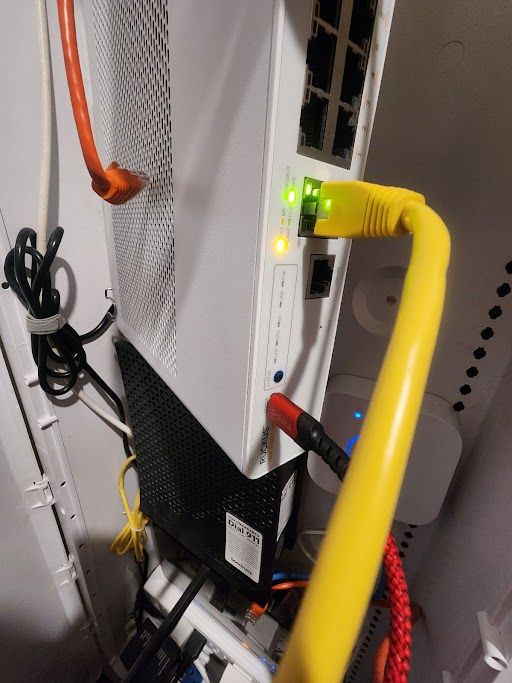 Switch - Red USB-A to USB-C cable connecting to console and yellow ethernet cable connected to Management Port